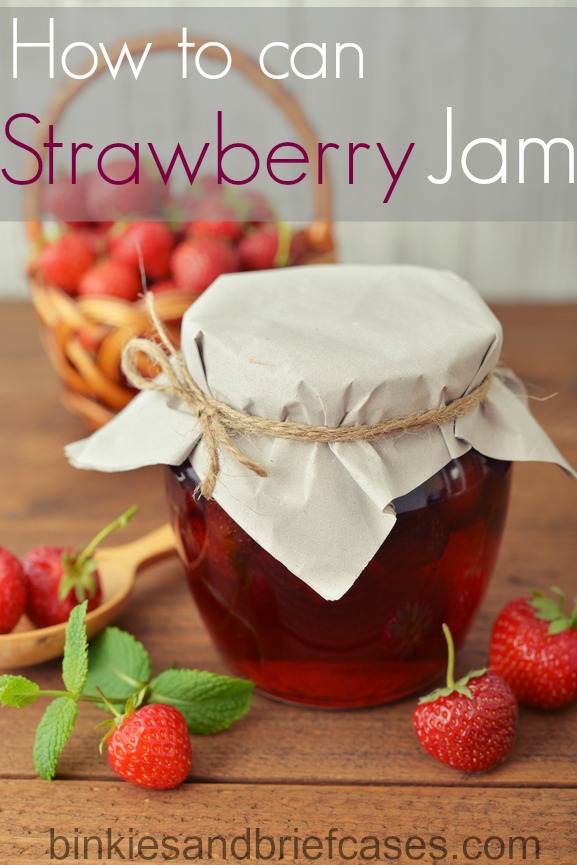 Strawberry jam in a jar with fresh berries on the wooden background